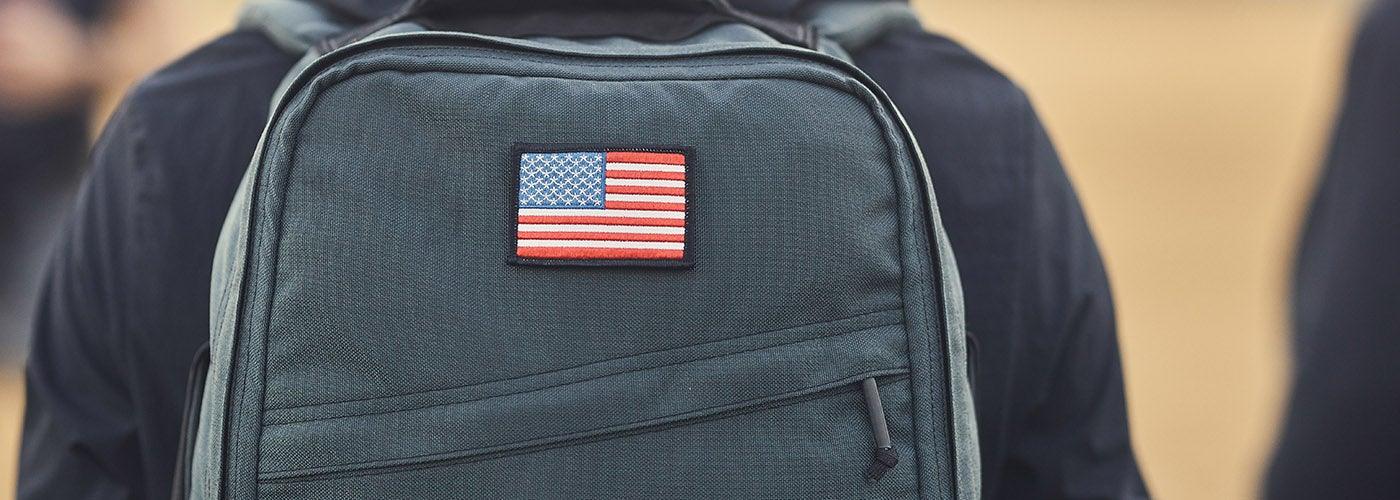 Close-up of durable black GORUCK backpack with American flag patch, ideal for tough rucking gear