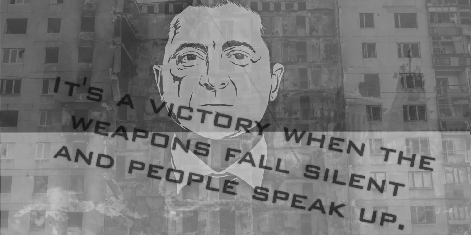 GORUCK Ukraine mural with man's face, damaged building, and 'It's a victory when the weapons fall silent and people speak up' quote.