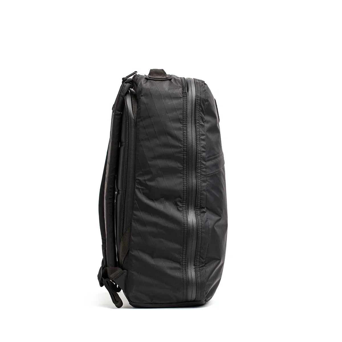 Side view of black GORUCK tactical backpack with padded straps and weather-resistant zippers on white background