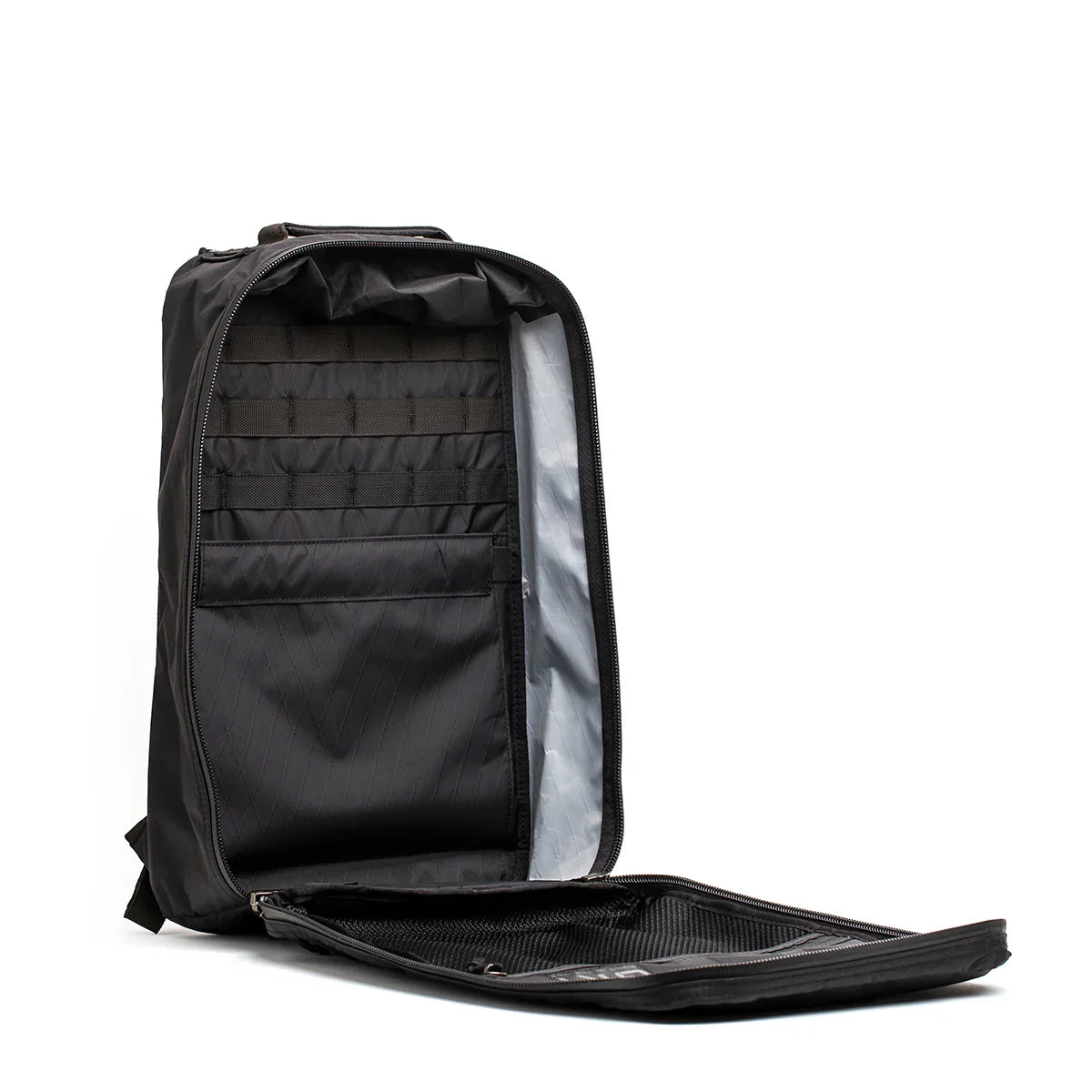 Black GORUCK backpack opened fully to show organized interior compartments and zippered pockets
