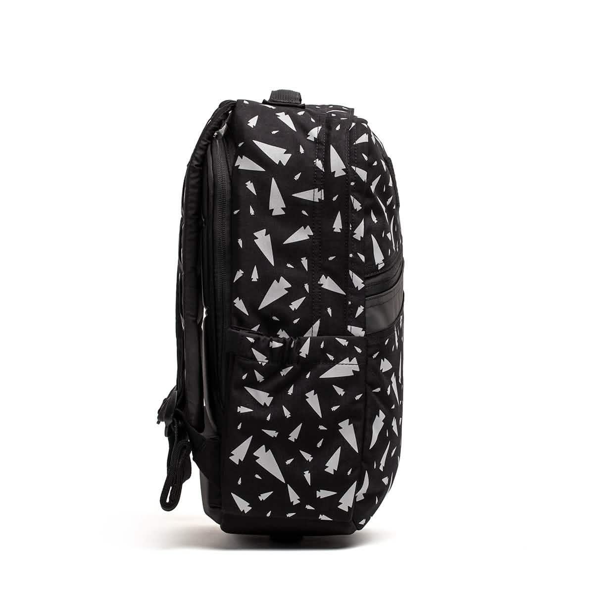 Side view of the REFLECTIVE KR1, a durable black book bag with white geometric triangle patterns, ideal as a school backpack, shown on a white background.
