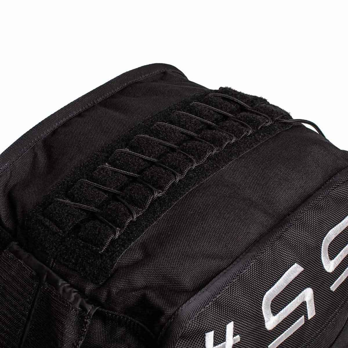 Close-up of a black GORUCK tactical backpack featuring durable fabric and stitched handle detail