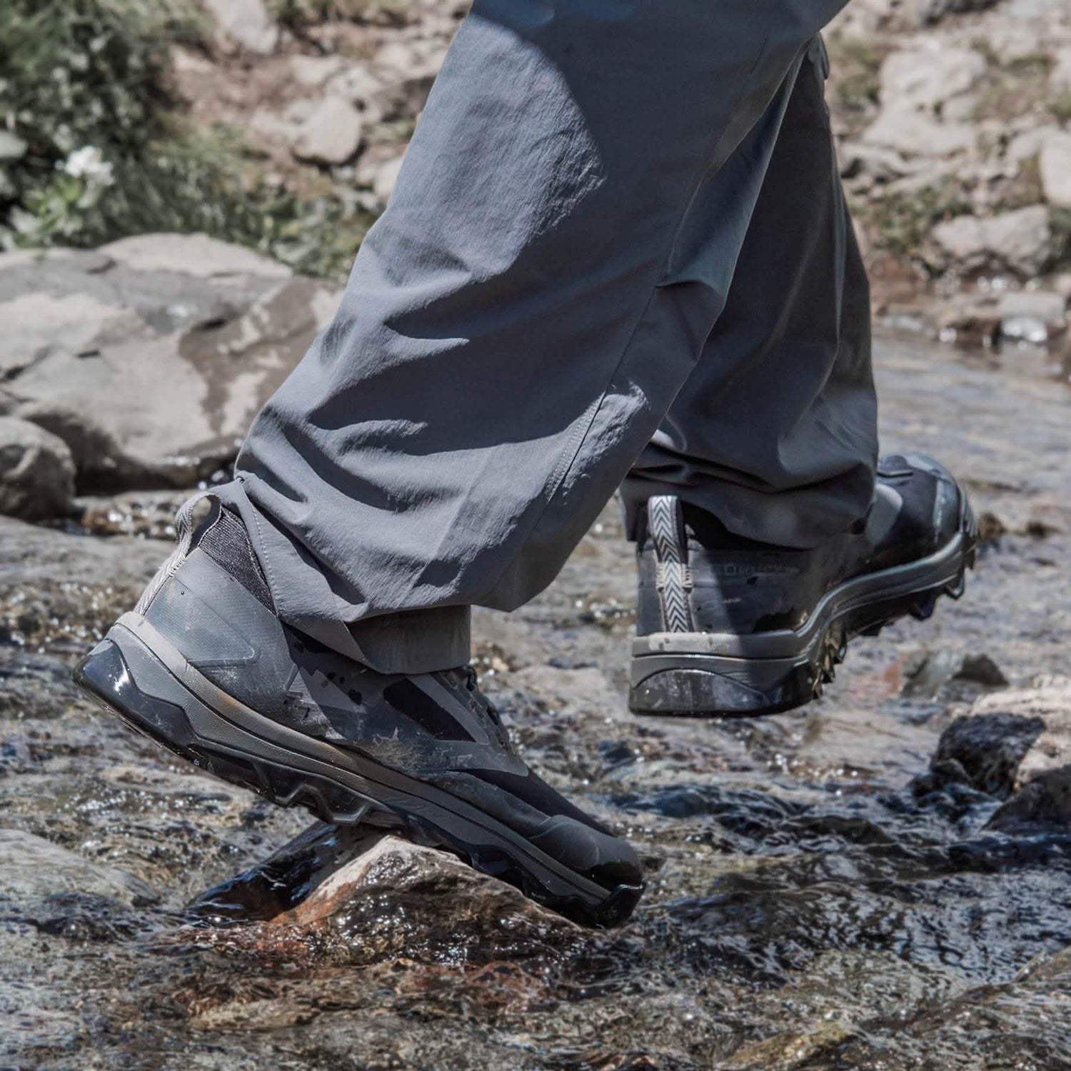 GORUCK rucking shoes in action crossing a rocky stream, outdoor adventure gear