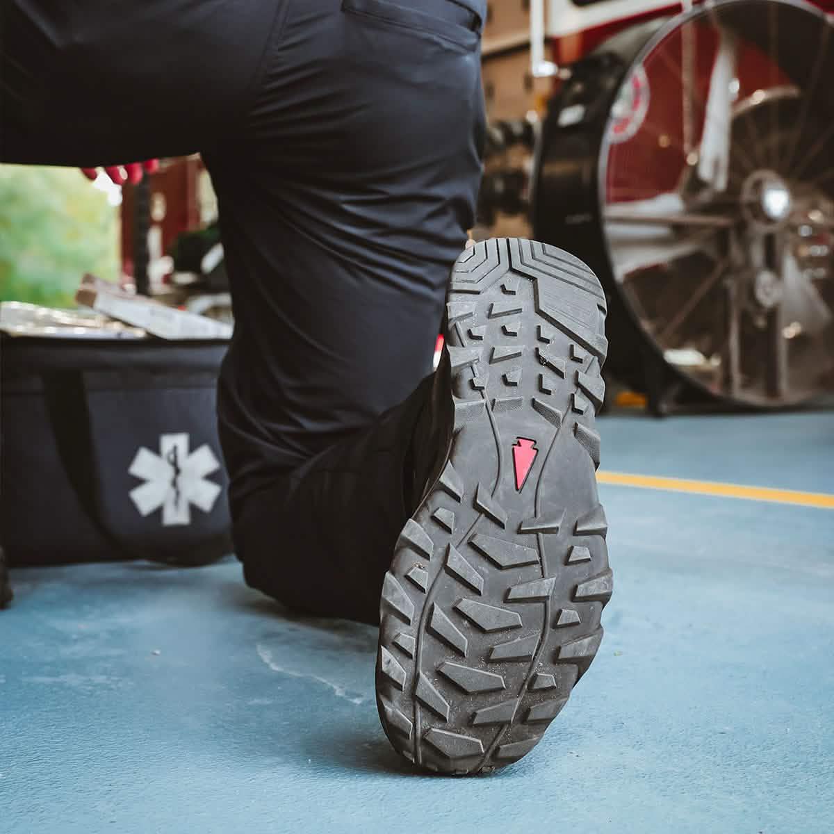 GORUCK tactical boot sole close-up in action on blue floor, emergency gear visible