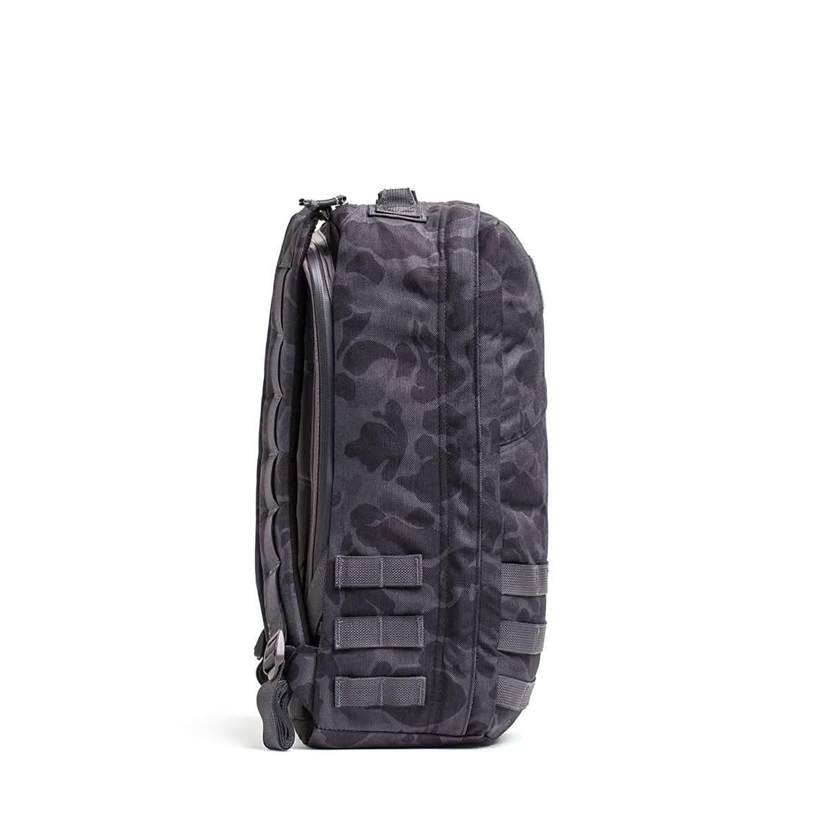 Side view of black frogskin camo GORUCK rucksack with MOLLE webbing and rugged fabric