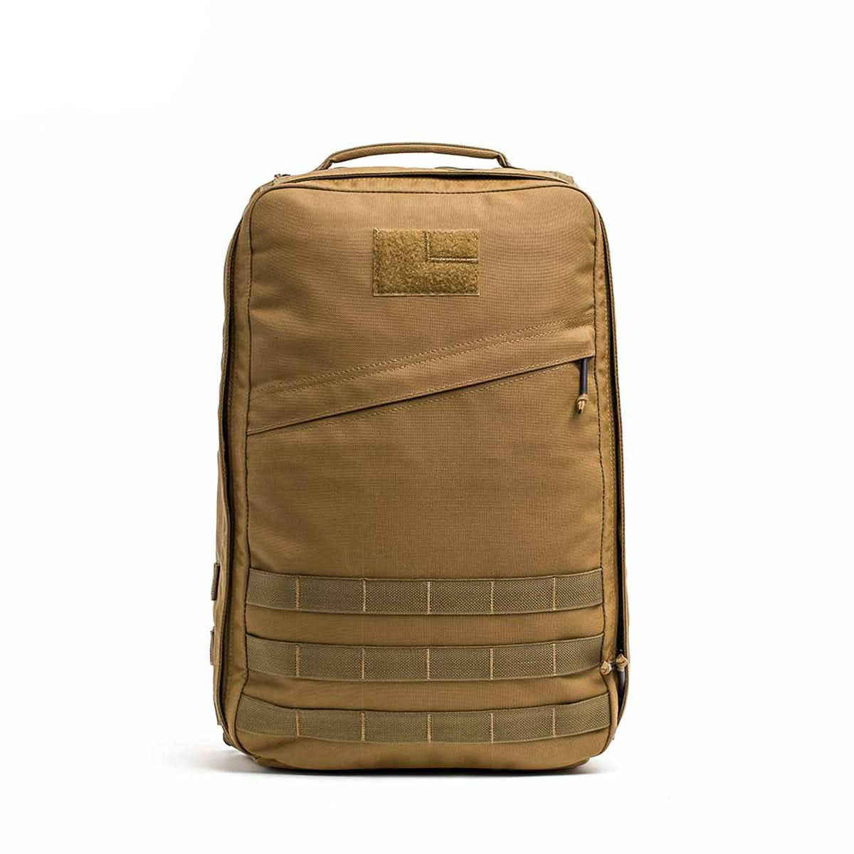 The GR1 USA - Cordura is a tan tactical backpack with a front zipper pocket, top handle, and bottom horizontal webbing—an American-made pack inspired by the GR1 rucksack for everyday or Special Forces use.