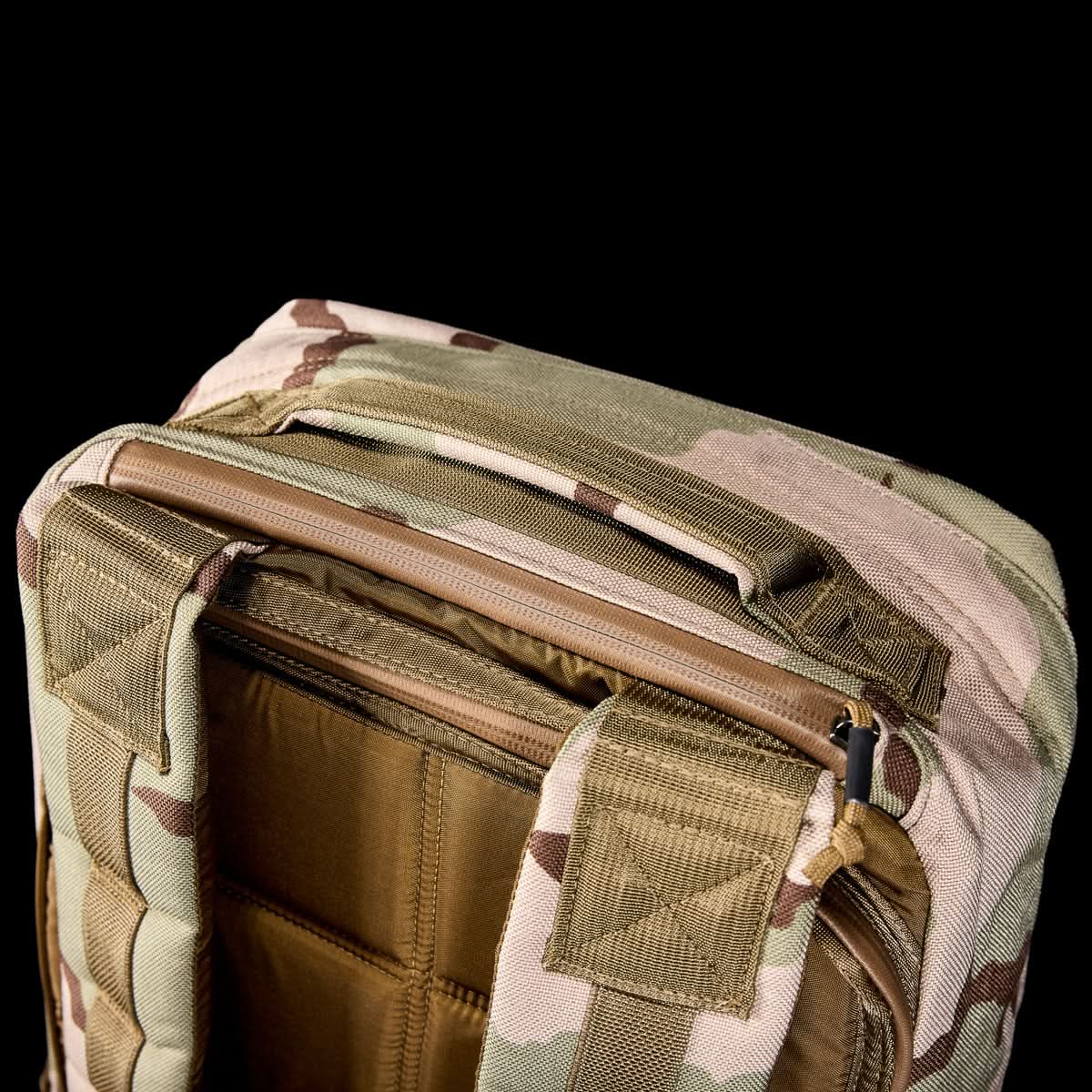 Close-up of the GR1 USA - Ballistic Nylon Cordura (The Original Ruck) 210D Back Panel, highlighting the top handle, zipper, and shoulder straps against a black background.