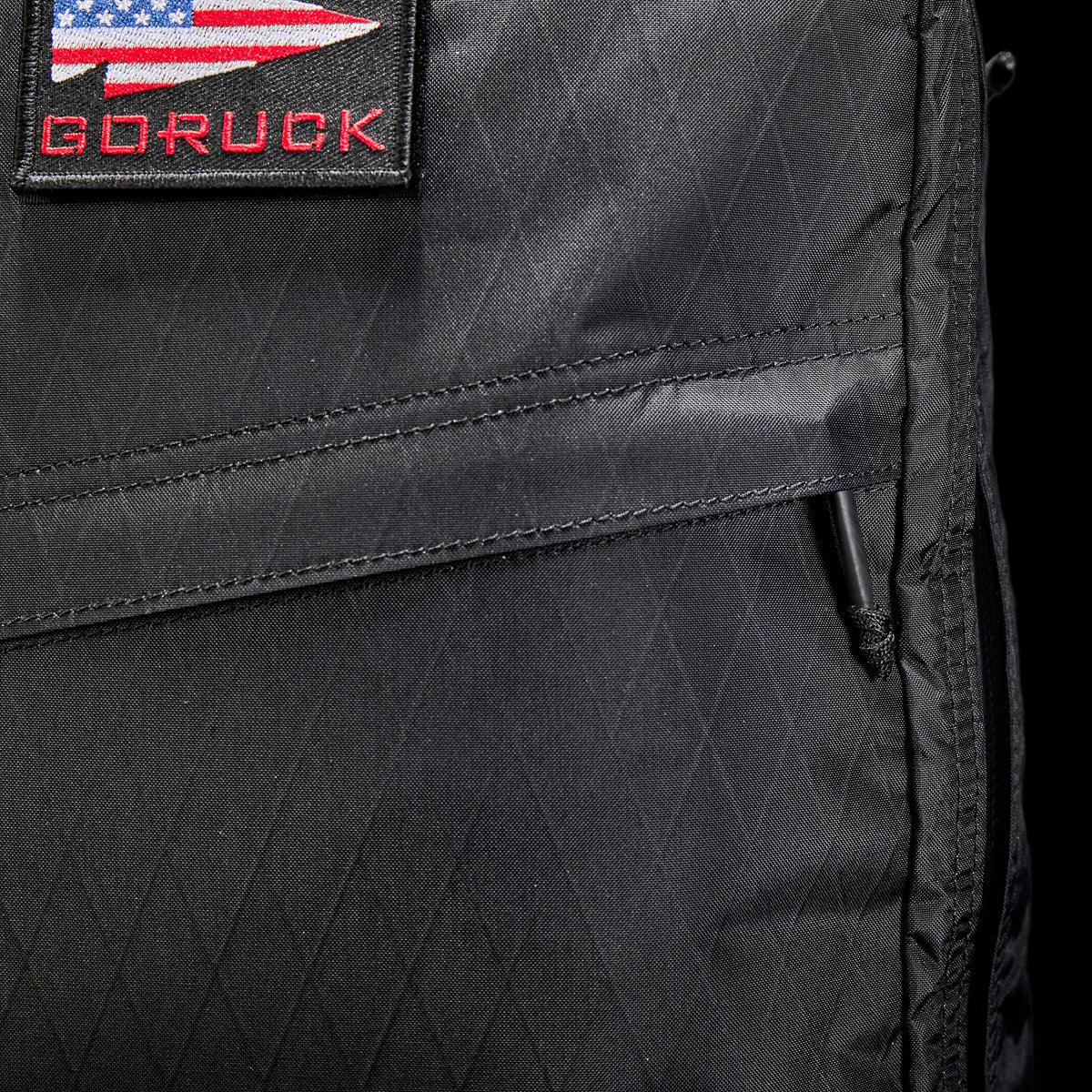 Close-up of black GORUCK rucksack with USA flag patch and rugged ripstop fabric