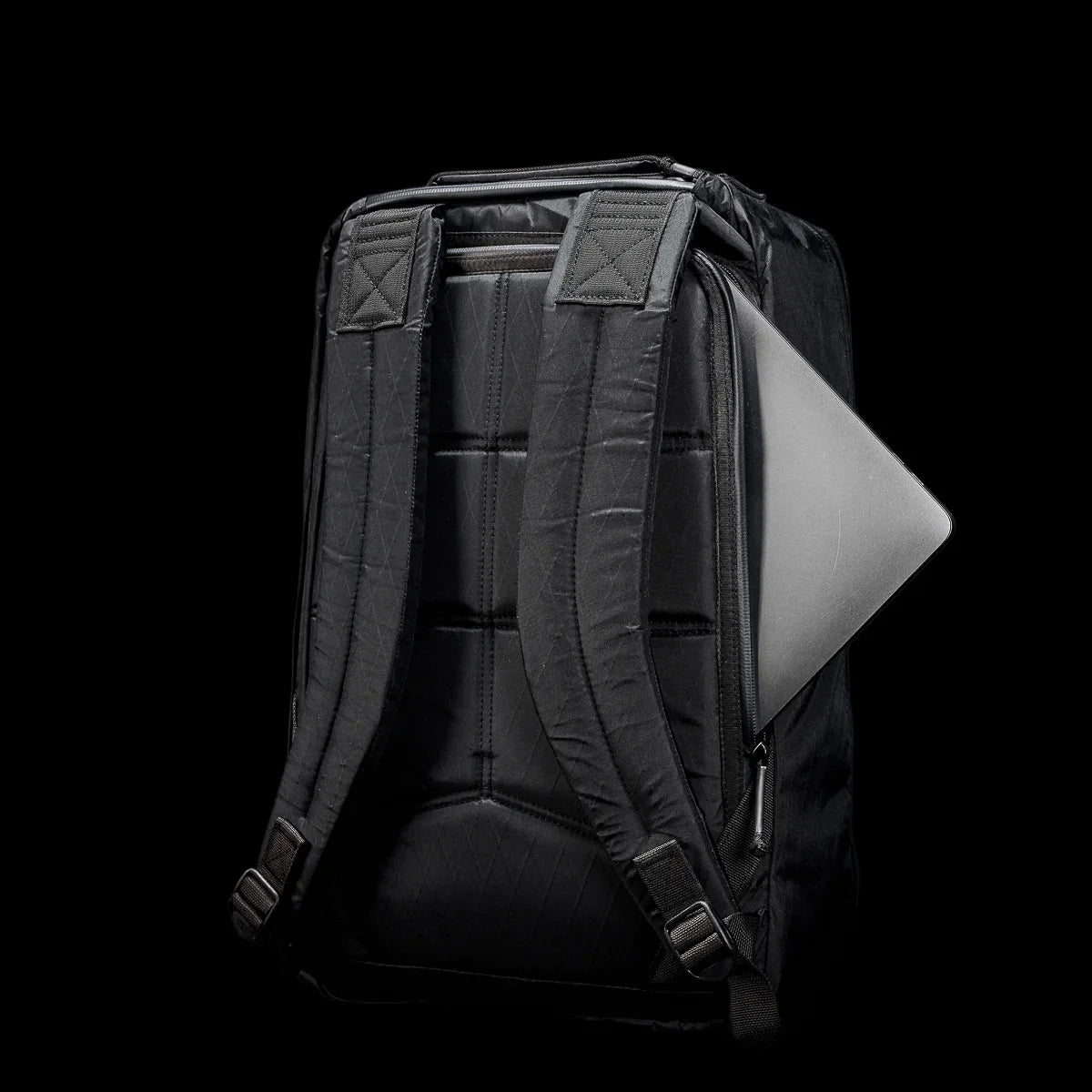 GORUCK black rugged backpack with padded straps and laptop partially visible in side compartment