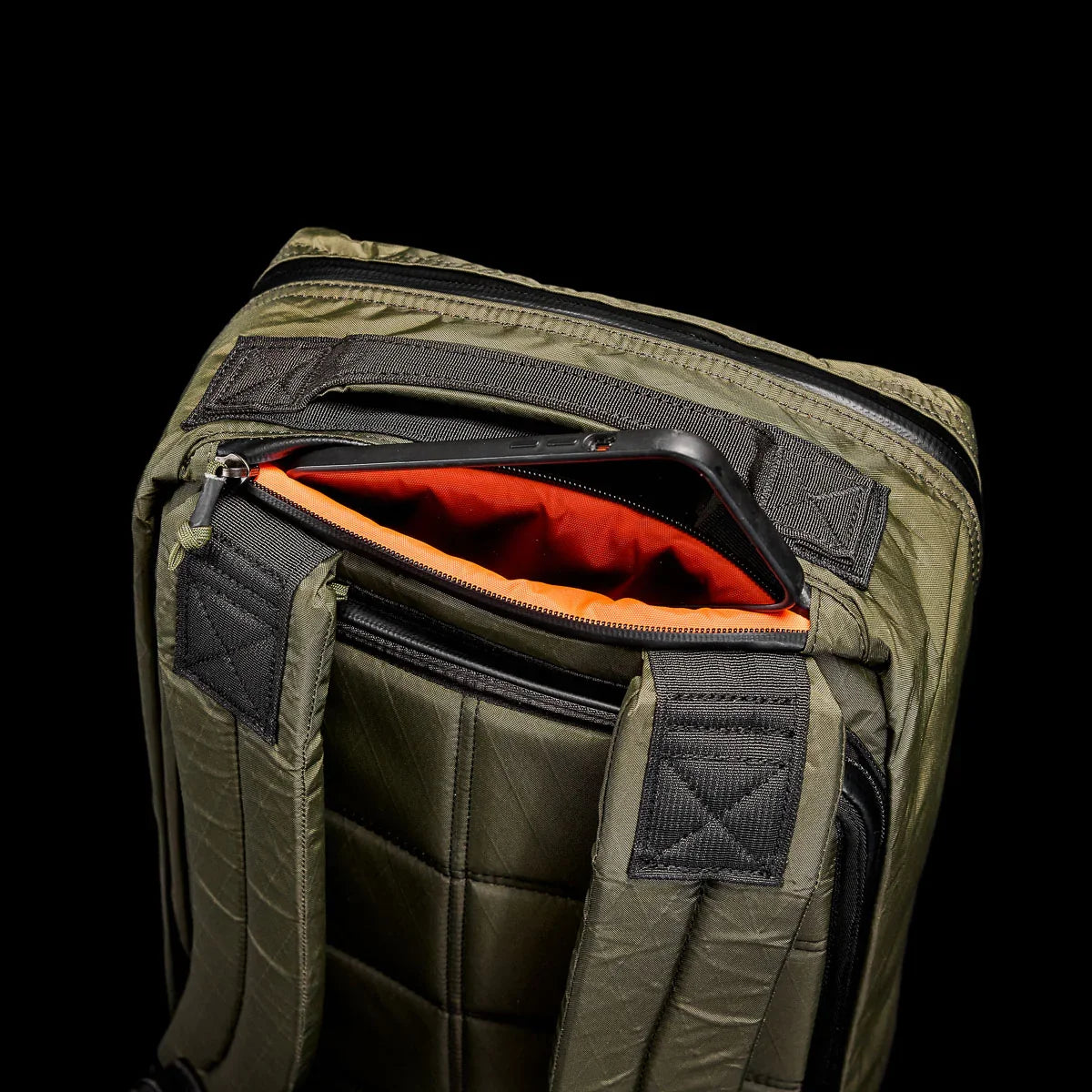GORUCK tough rucking backpack in dark green with padded straps and orange interior zipper pocket