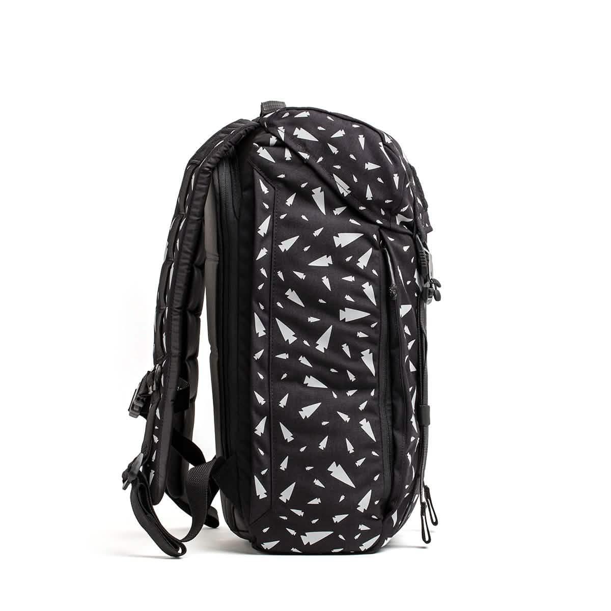 M23 - Ballistic Nylon Cordura: Black backpack with white geometric triangles, side view on white background—a stylish, durable everyday carry for any adventure.