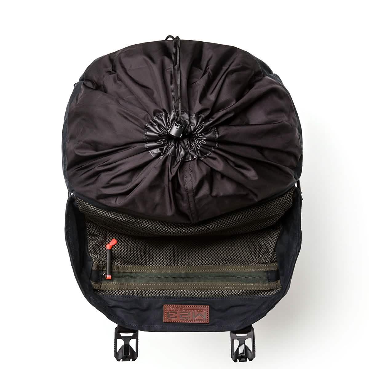 Top view of GORUCK black rucksack with cinch closure and mesh zippered pocket inside