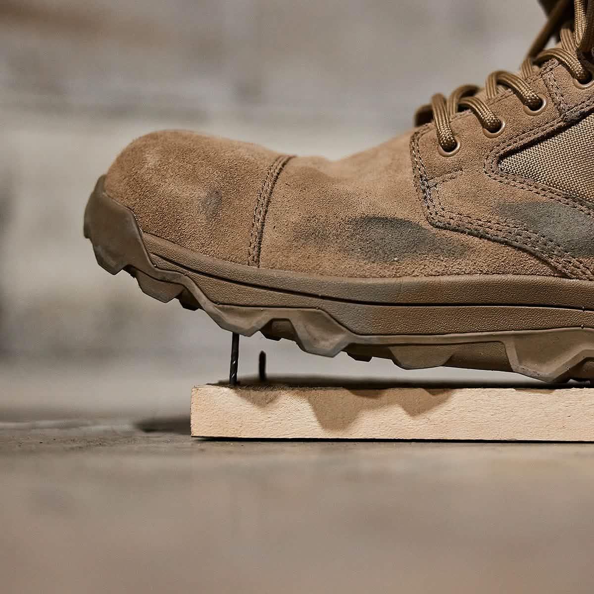 GORUCK rugged brown rucking boot showing puncture-resistant sole on nail for durability test