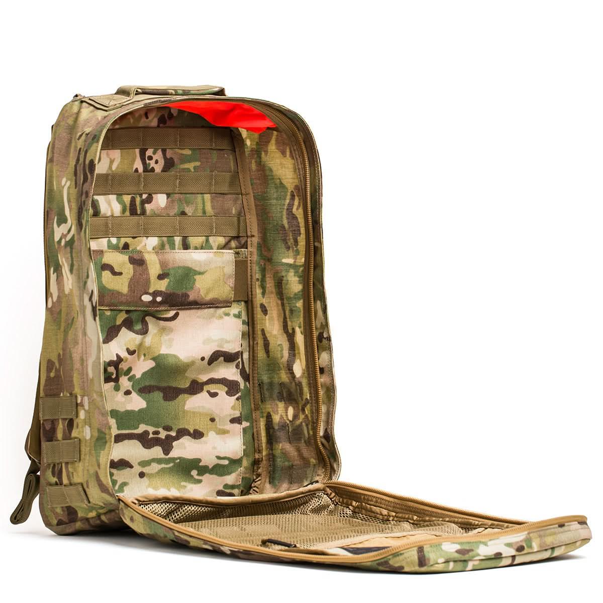 Open GORUCK Multicam rucksack showing spacious interior pockets and red lining accents