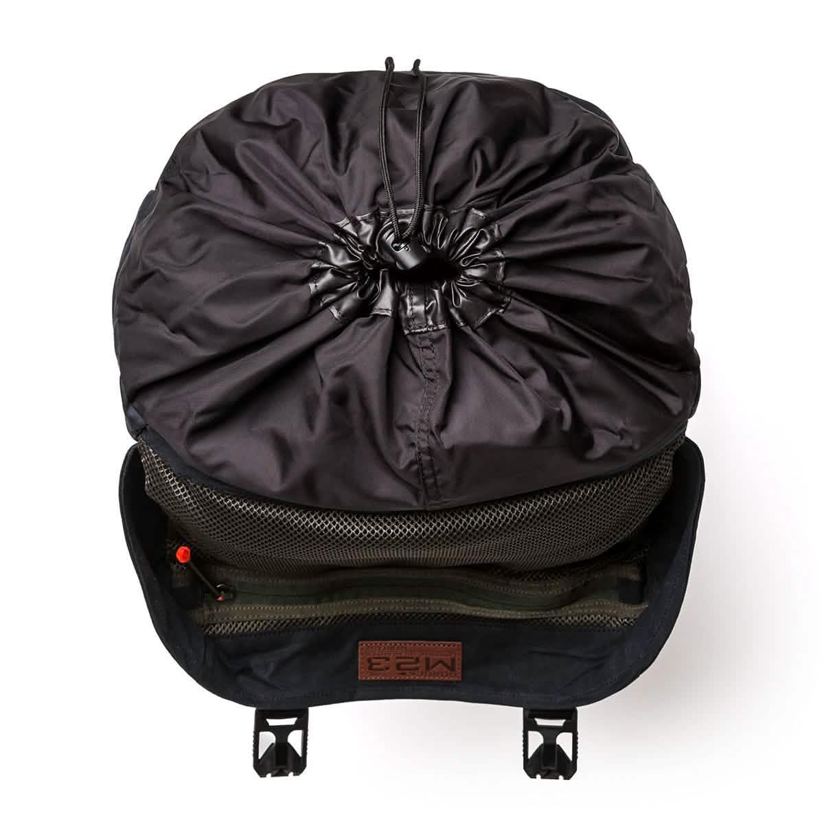 Top view of GORUCK black rucksack showing main compartment with mesh pocket and drawstring closure
