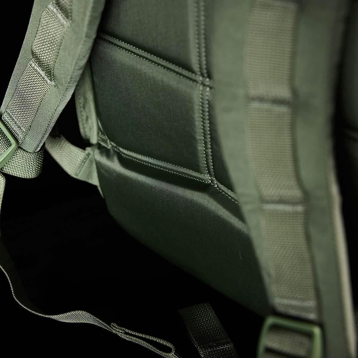 Close-up of padded green tactical backpack straps designed for durable rucking gear by GORUCK