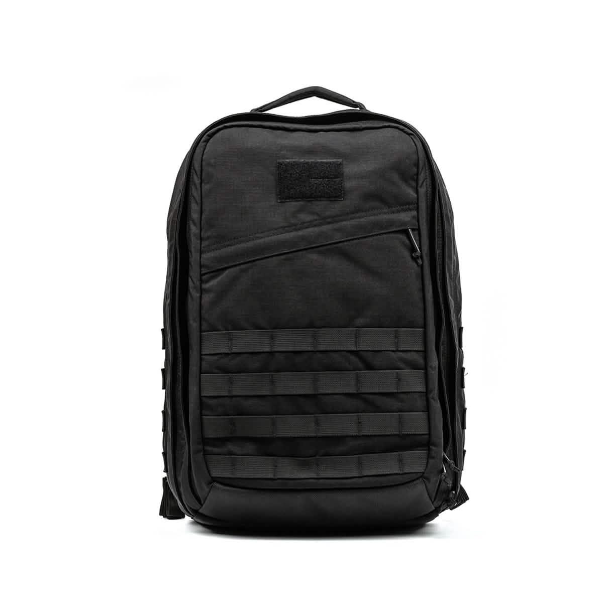 Black GORUCK tactical ruck sack with zippered front pocket and MOLLE webbing on white background