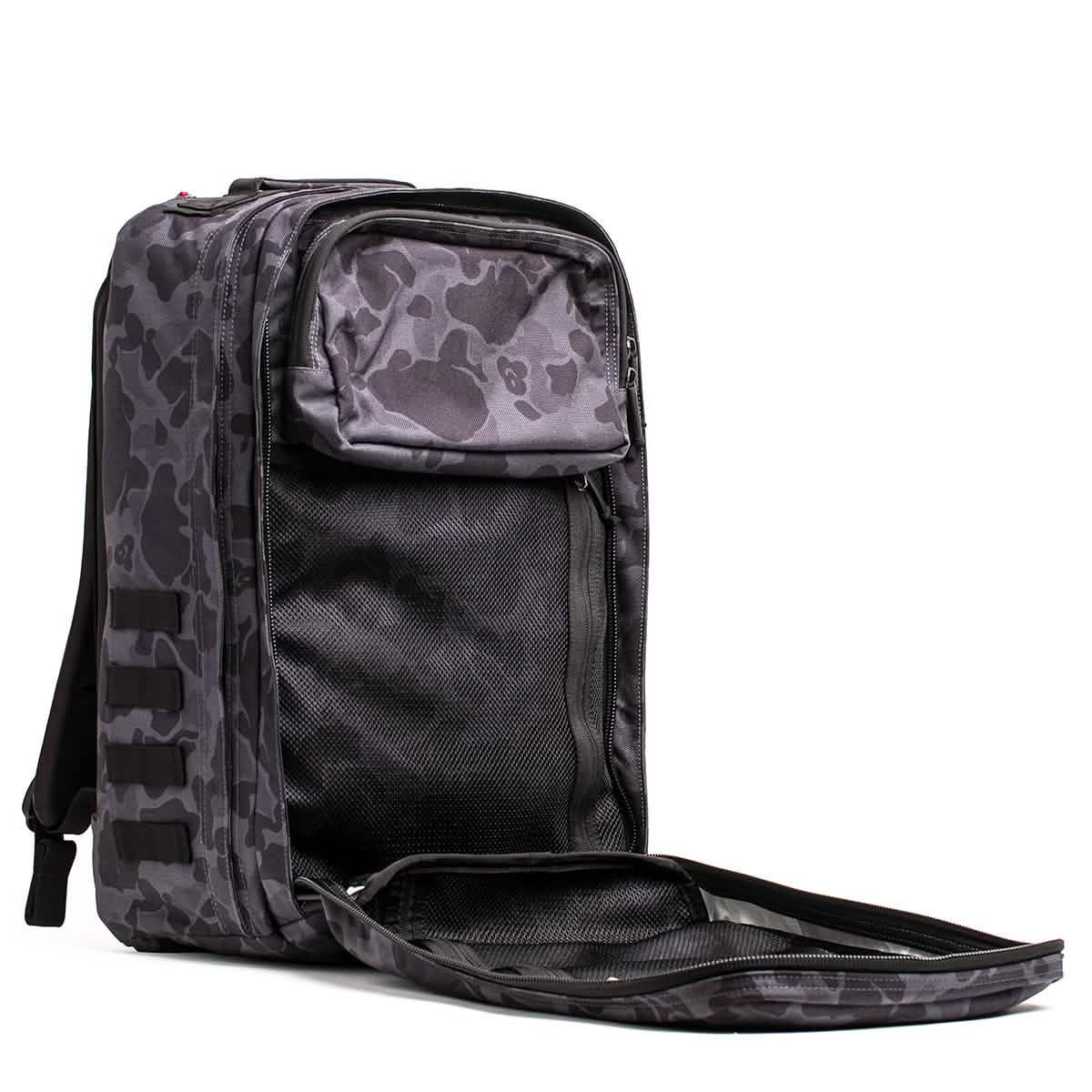 GORUCK rucksack open to show black frogskin camo design with spacious compartments and mesh pockets