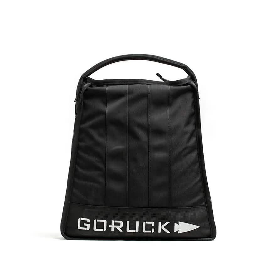 Black GORUCK bag with top handle and white logo on front, tough rucking gear for outdoor training