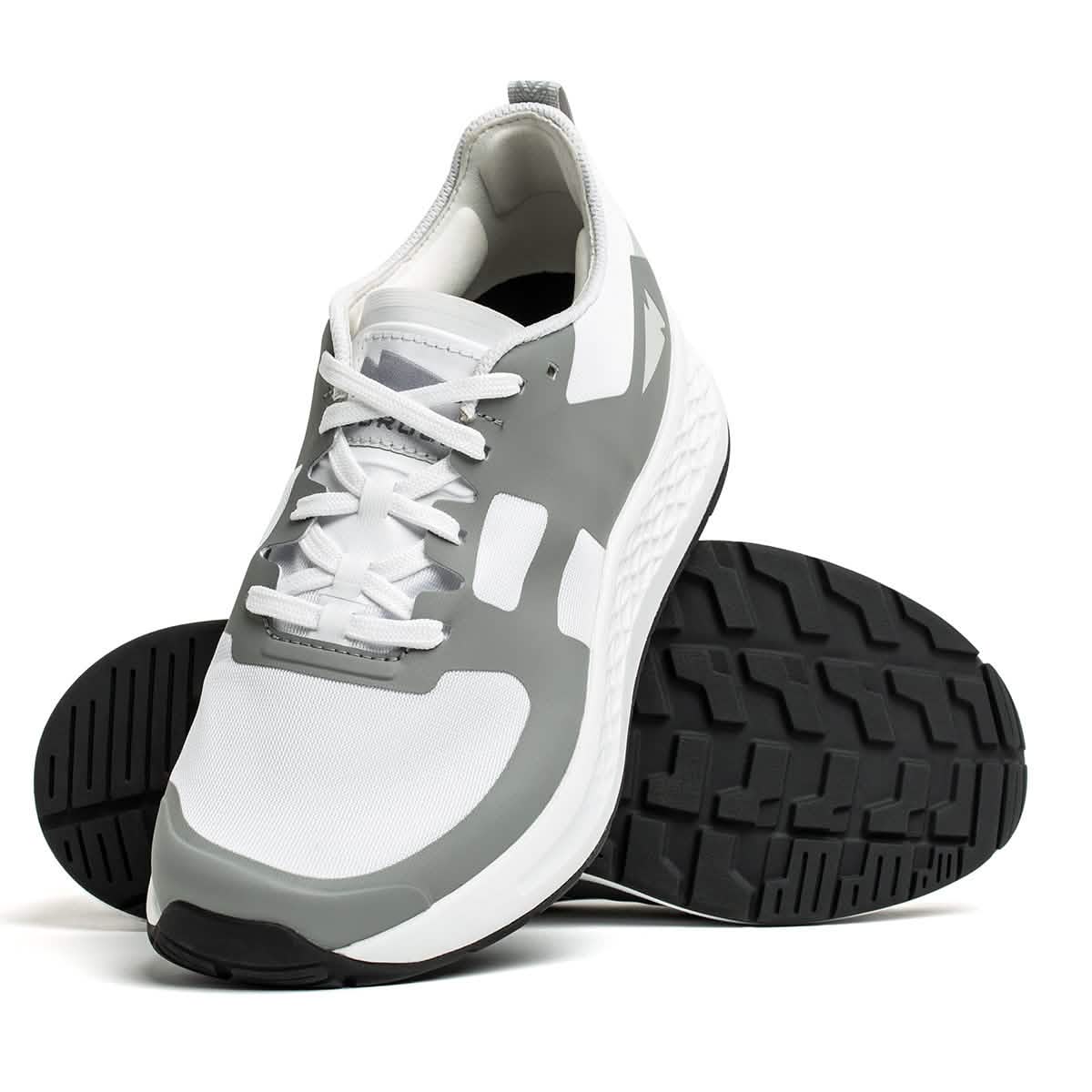 The Men's Rough Runner - White + Speed Grey running shoes by GORUCK showcase a white and speed grey design. One shoe is upright, highlighting the textured black sole, while the other rests at an angle. These Rough Runner™ shoes come with white laces and a white mesh upper accented by gray for added durability and style.
