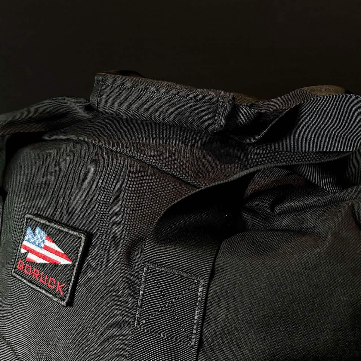 GORUCK black rucksack with USA flag patch and durable straps, close-up on black background