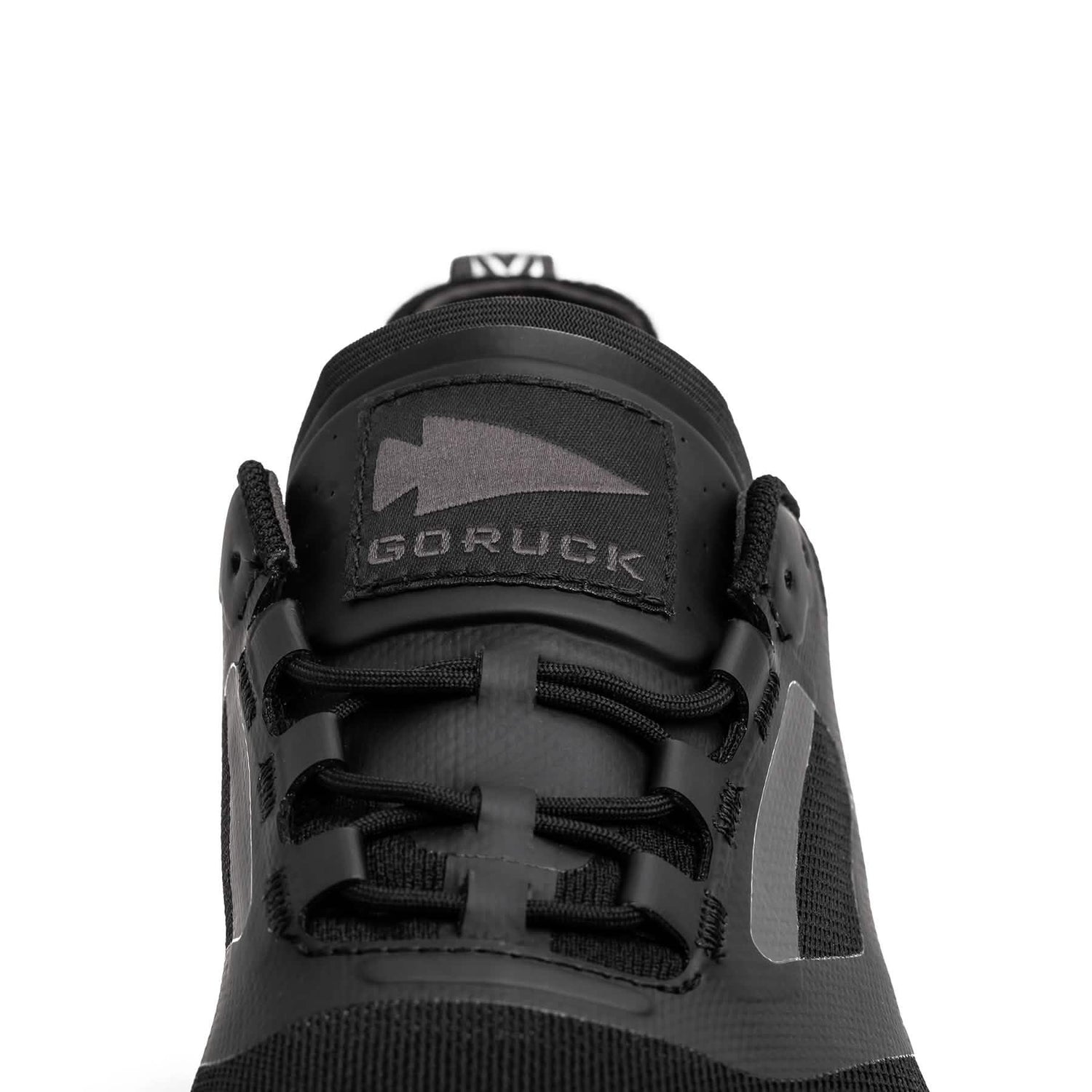 Close-up of black GORUCK rucking shoe with logo on tongue and durable laces