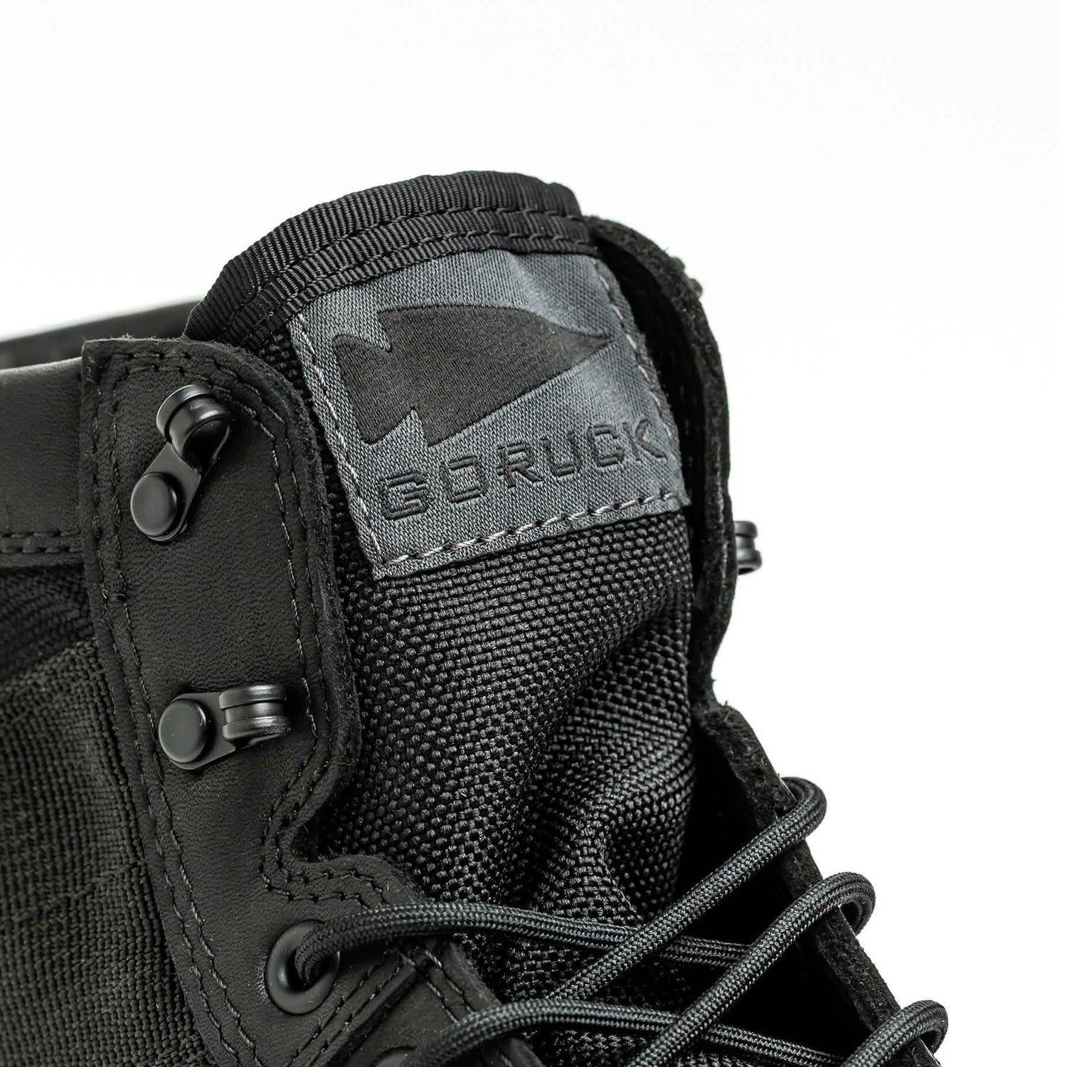 Close-up of GORUCK black rucking boot with arrowhead logo on the tongue