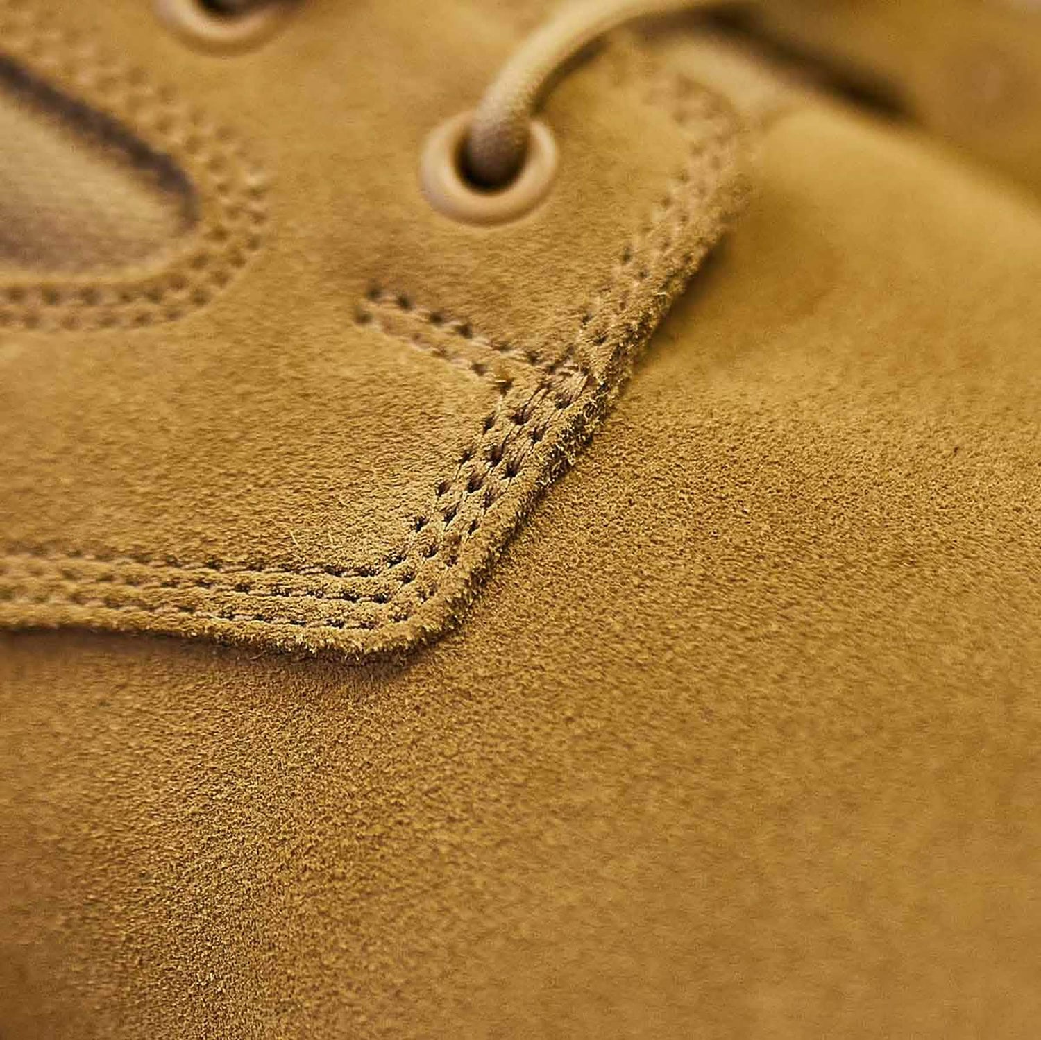 Close-up of the MACV-1 Hi-Speed - High Top by GORUCK, highlighting the detailed stitching near the laces reminiscent of lightweight rucking boots. The texture of the brown suede material and eyelets is prominently visible.