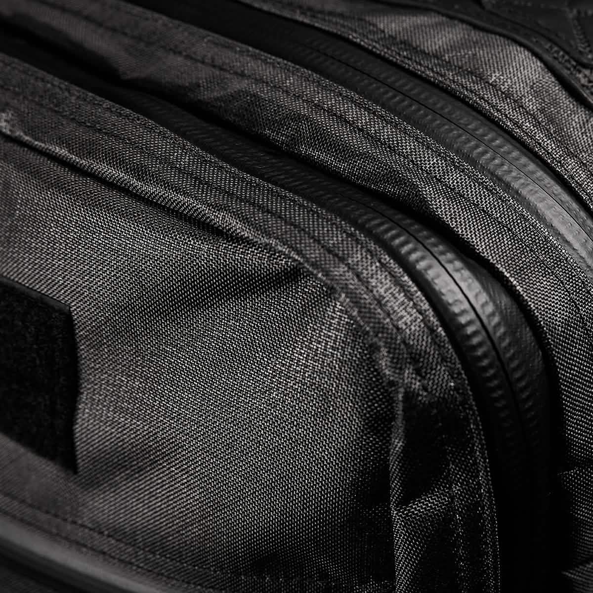 Close-up of the GR2 USA x Carryology - Ultra Black backpack, showcasing its textured UHMWPE fabric, zippers, and Velcro patch.