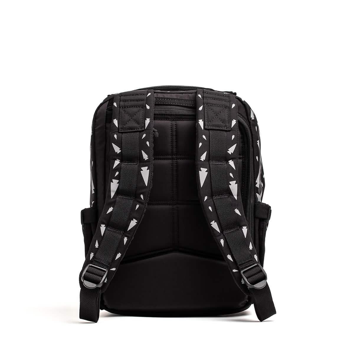 The REFLECTIVE KR1 is a durable black backpack shown from the back, featuring padded straps with a white geometric pattern.