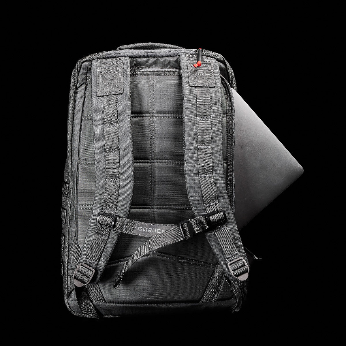 GORUCK Armor Grey backpack back view with padded straps and laptop partially inside main compartment