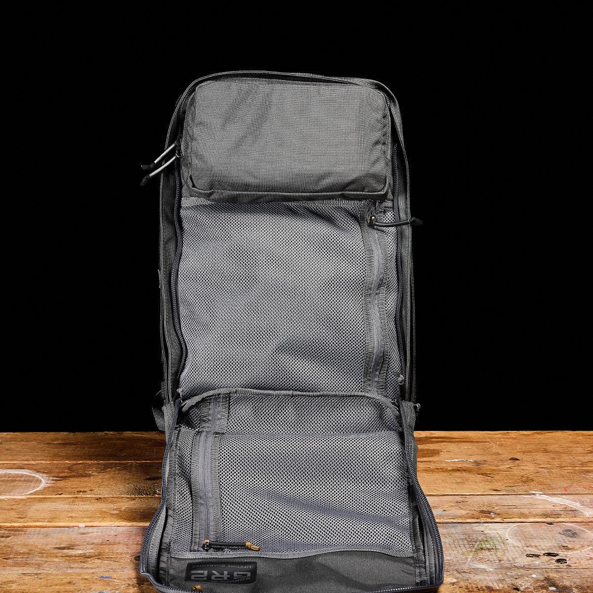 GORUCK Armor grey rucksack open showing spacious internal mesh compartments and durable design