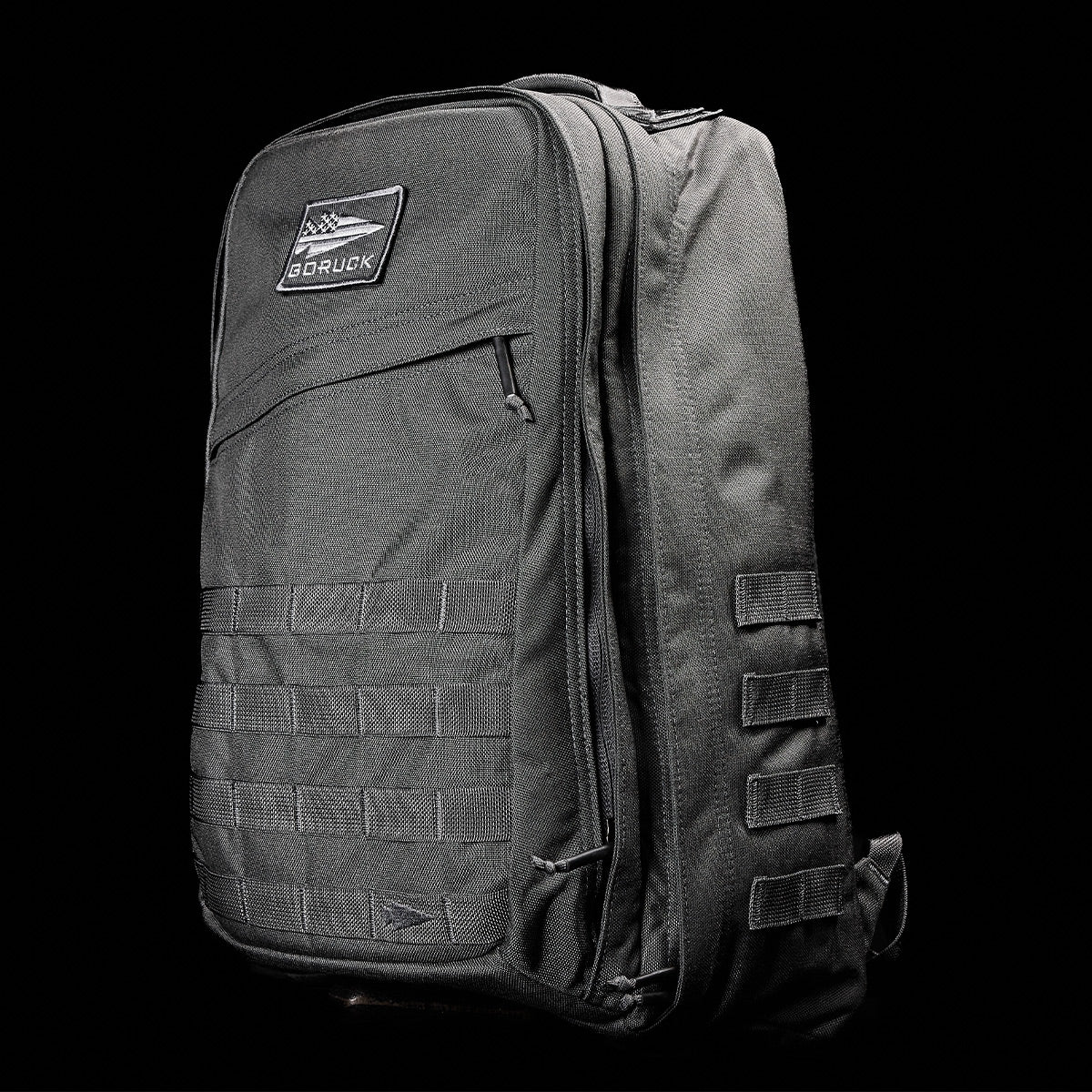 GORUCK Armor Grey tough rucking backpack with MOLLE webbing and front zipper pocket on black background