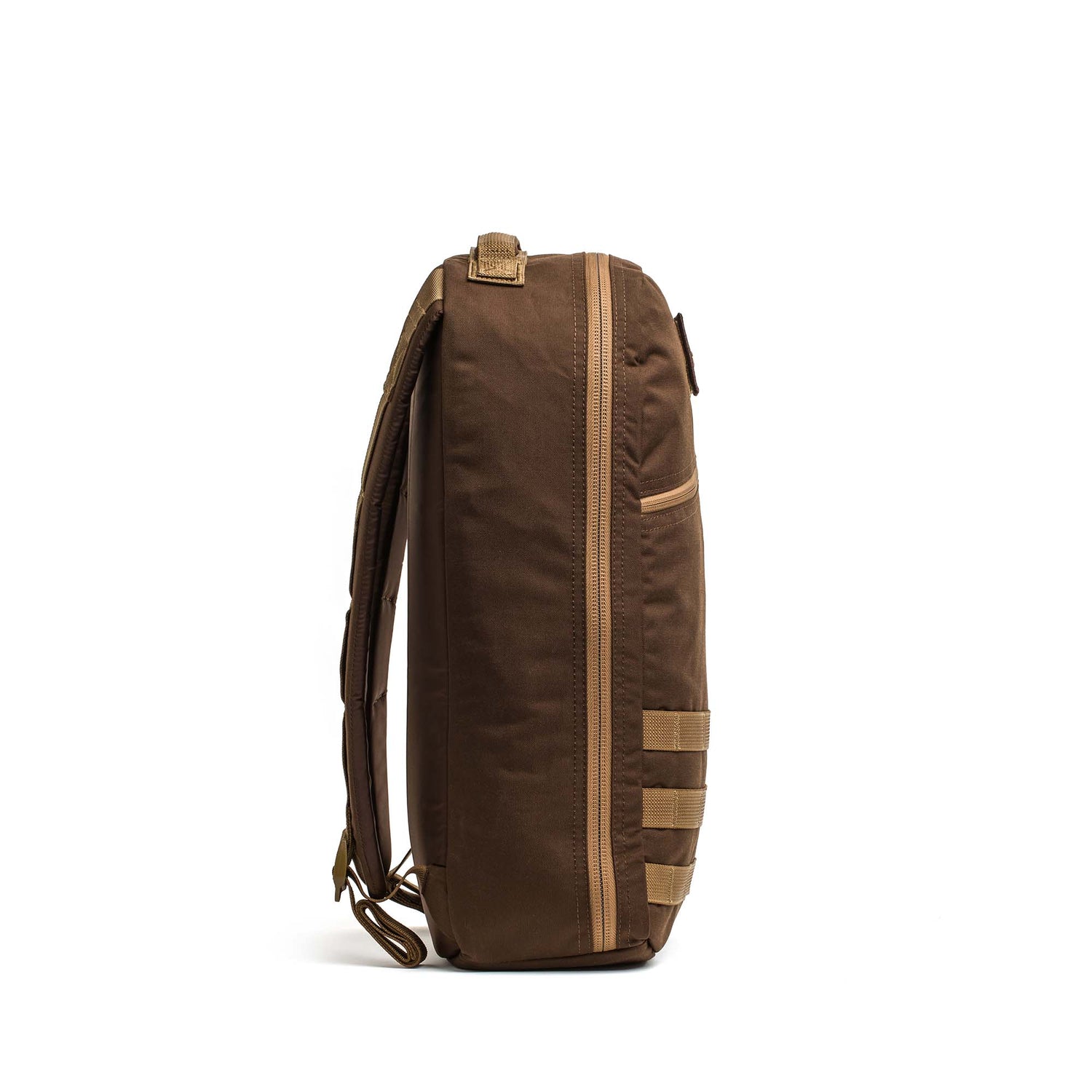 Side view of the Bullet Ruck Classic - Ballistic Nylon Cordura, a brown 15L daypack with multiple straps and zipper, standing upright on a white background.