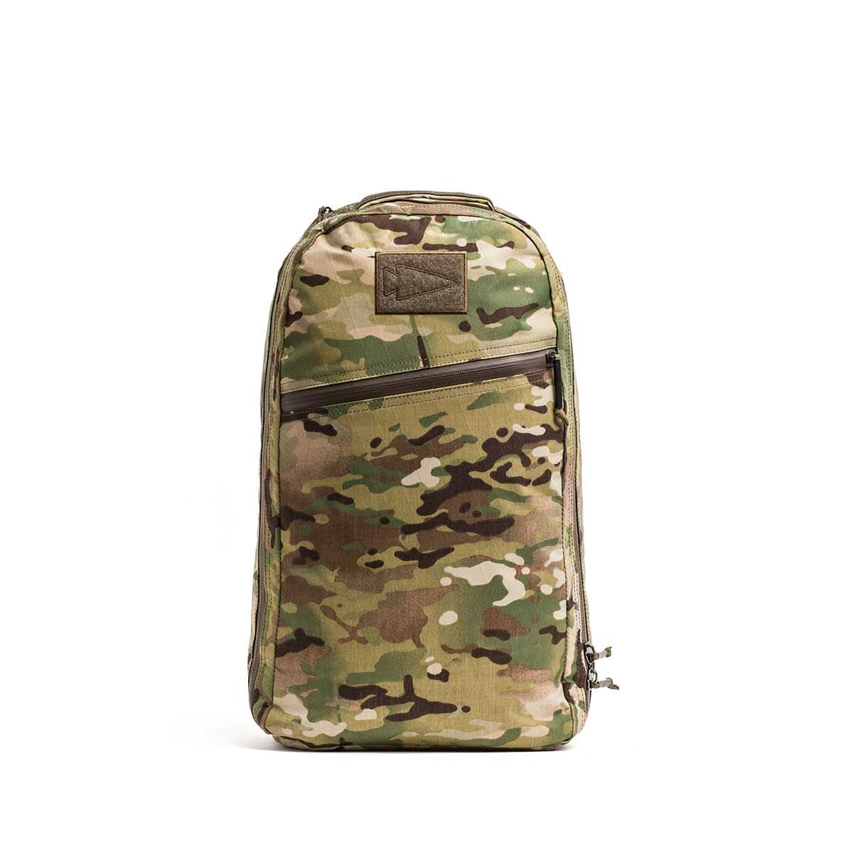 The Bullet X-PAC daypack, featuring a camouflage pattern and AquaGuard zippers, stands upright against a white background.