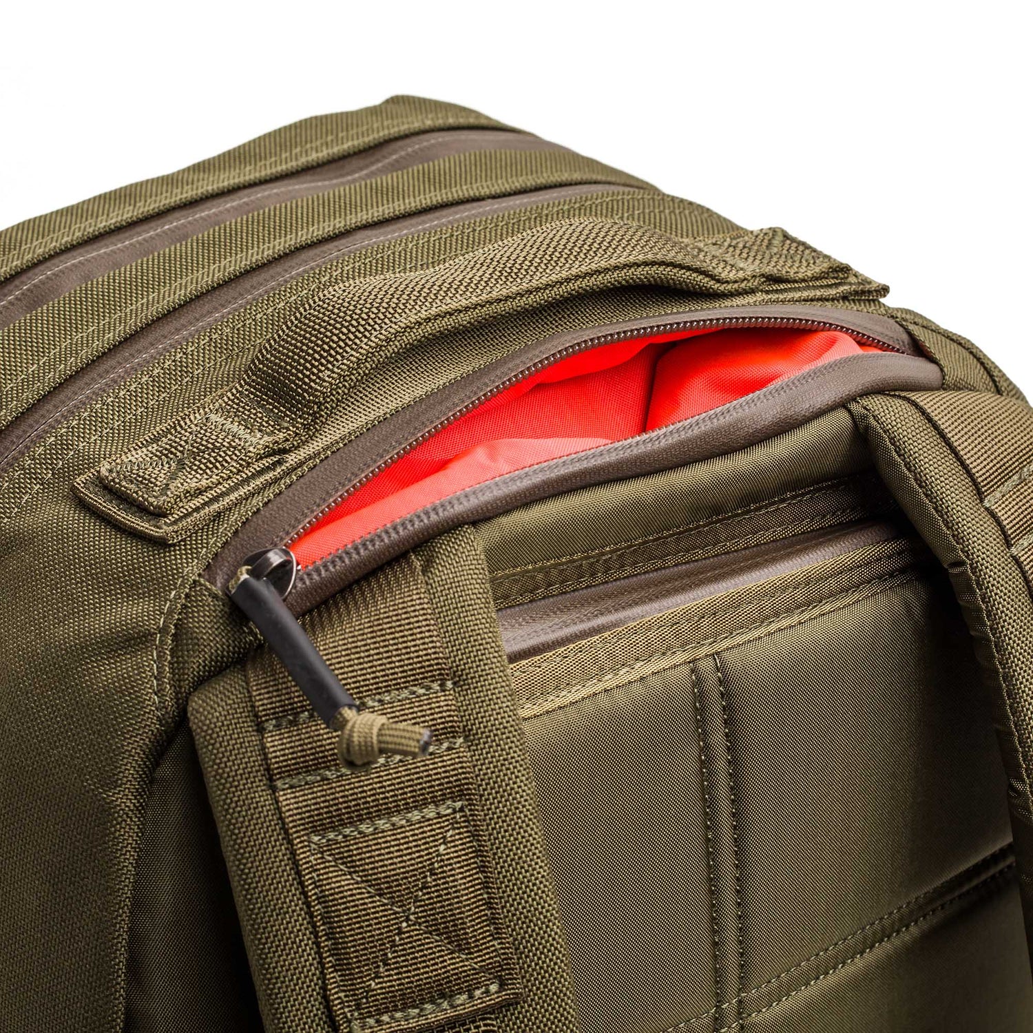 Close-up of the Double Compartment Bullet Ruck - Ballistic Nylon Cordura - 18L in olive green, with a partially open zipper showing its bright orange interior and bombproof laptop compartment.