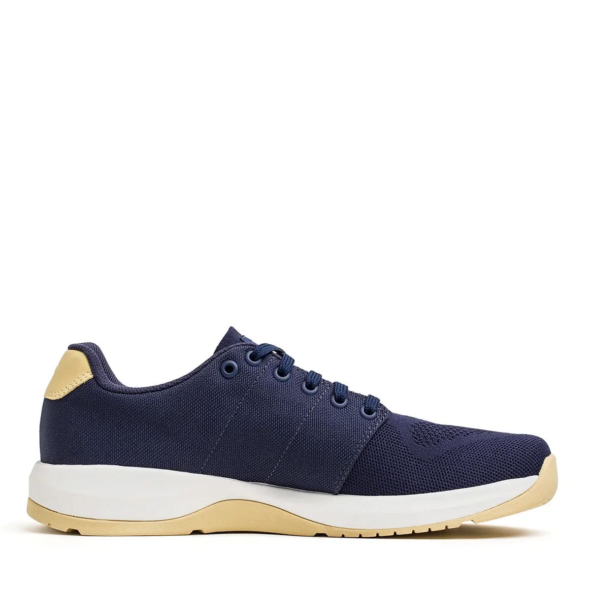 GORUCK Ballistic Trainer shoe navy blue with white and gold sole, side view on white