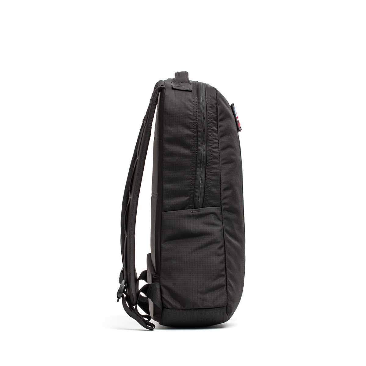 Side view of black GORUCK Basic Rucker backpack showing slim profile and padded shoulder straps
