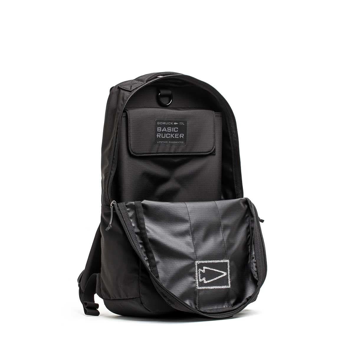 Black Basic Rucker® backpack with an open front pocket, displaying a patch labeled