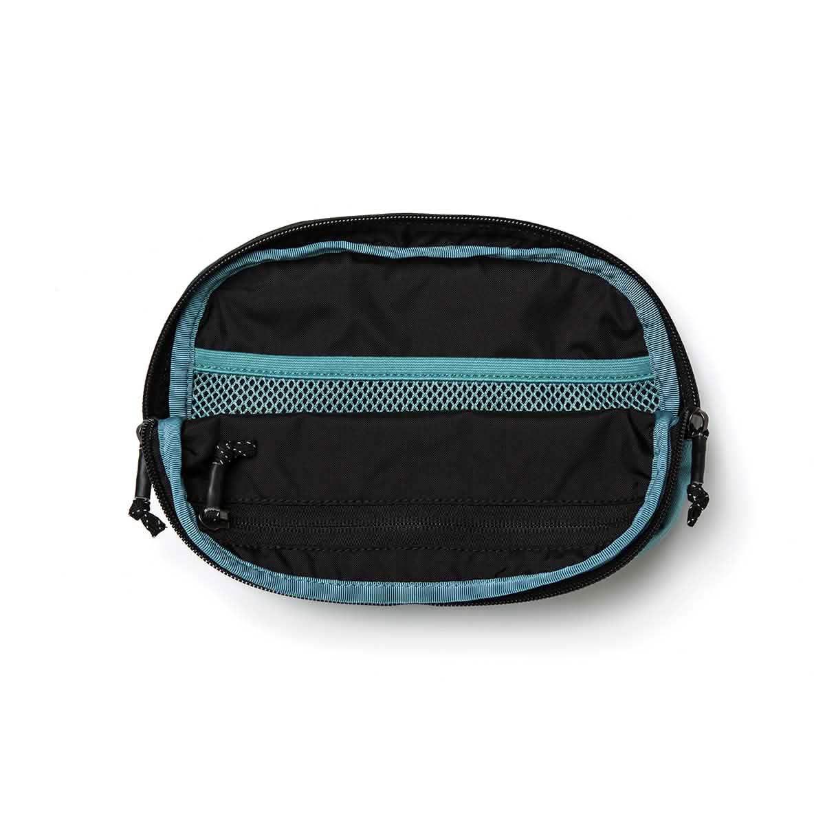 Open GORUCK teal and black belt bag showing internal mesh and zippered pockets
