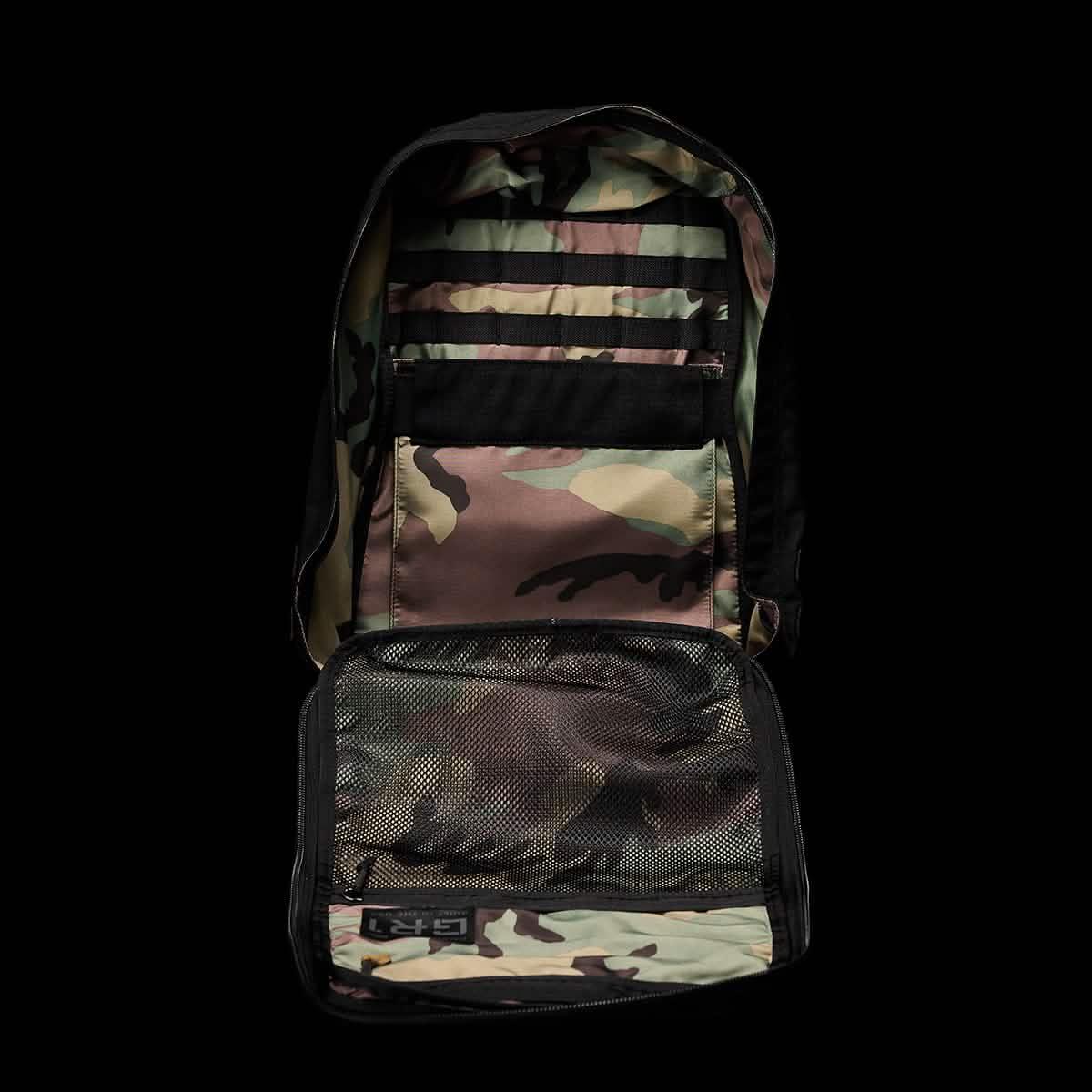 Open GORUCK rucksack showing interior camouflage fabric, mesh pocket, and organization straps