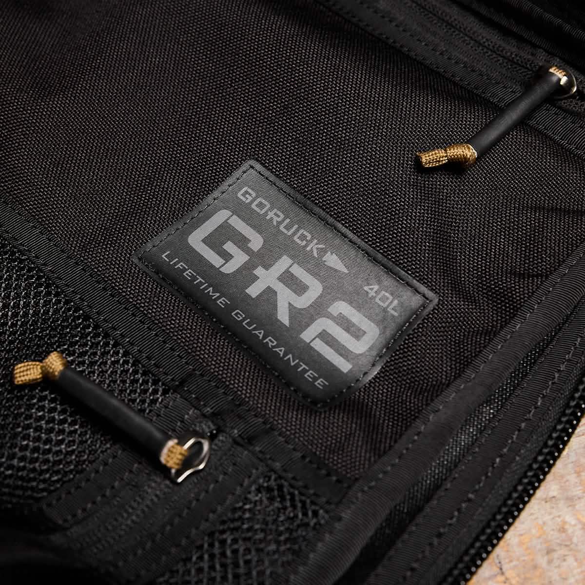 Close-up of GORUCK GR2 40L rucksack black label with lifetime guarantee on tactical fabric