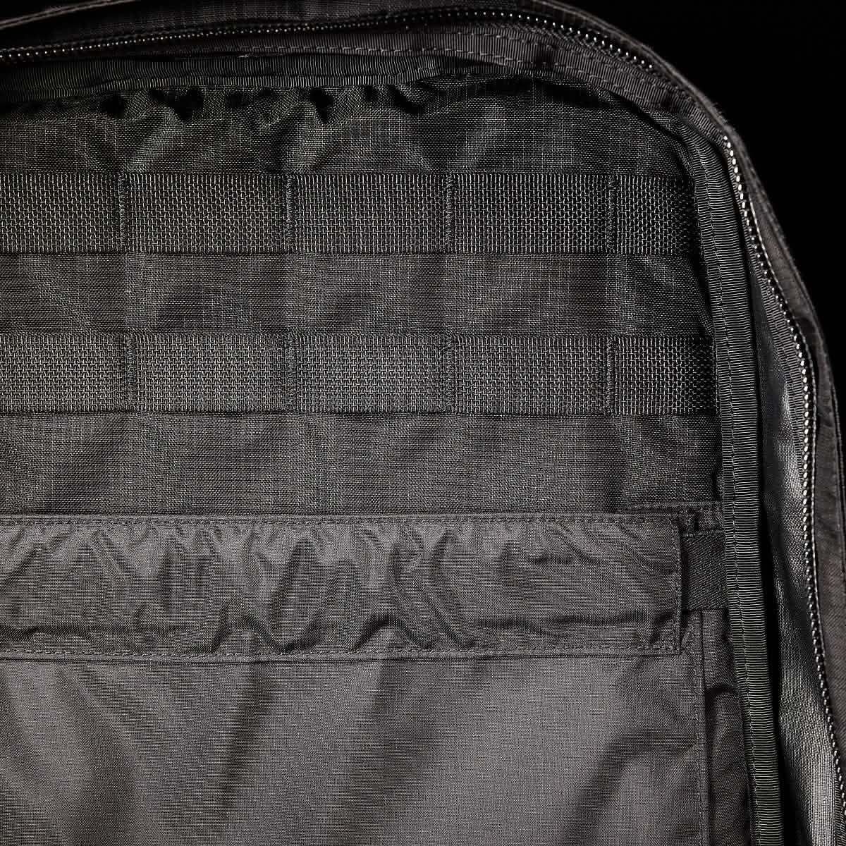 Close-up of the GR0 - Ripstop ROBIC® rucksack interior, showcasing MOLLE webbing and a zippered compartment—perfect for minimalist everyday carry or anyone seeking a water-resistant backpack.