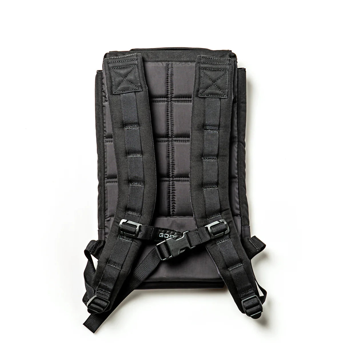 Black GORUCK weight plate with padded back and adjustable shoulder straps for rucking