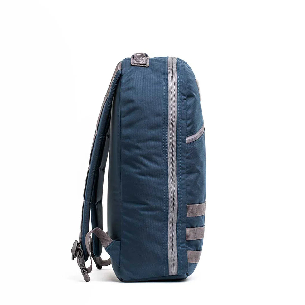 Side view of GORUCK Bullet 15 backpack in dark sea blue with armor grey accents and padded straps