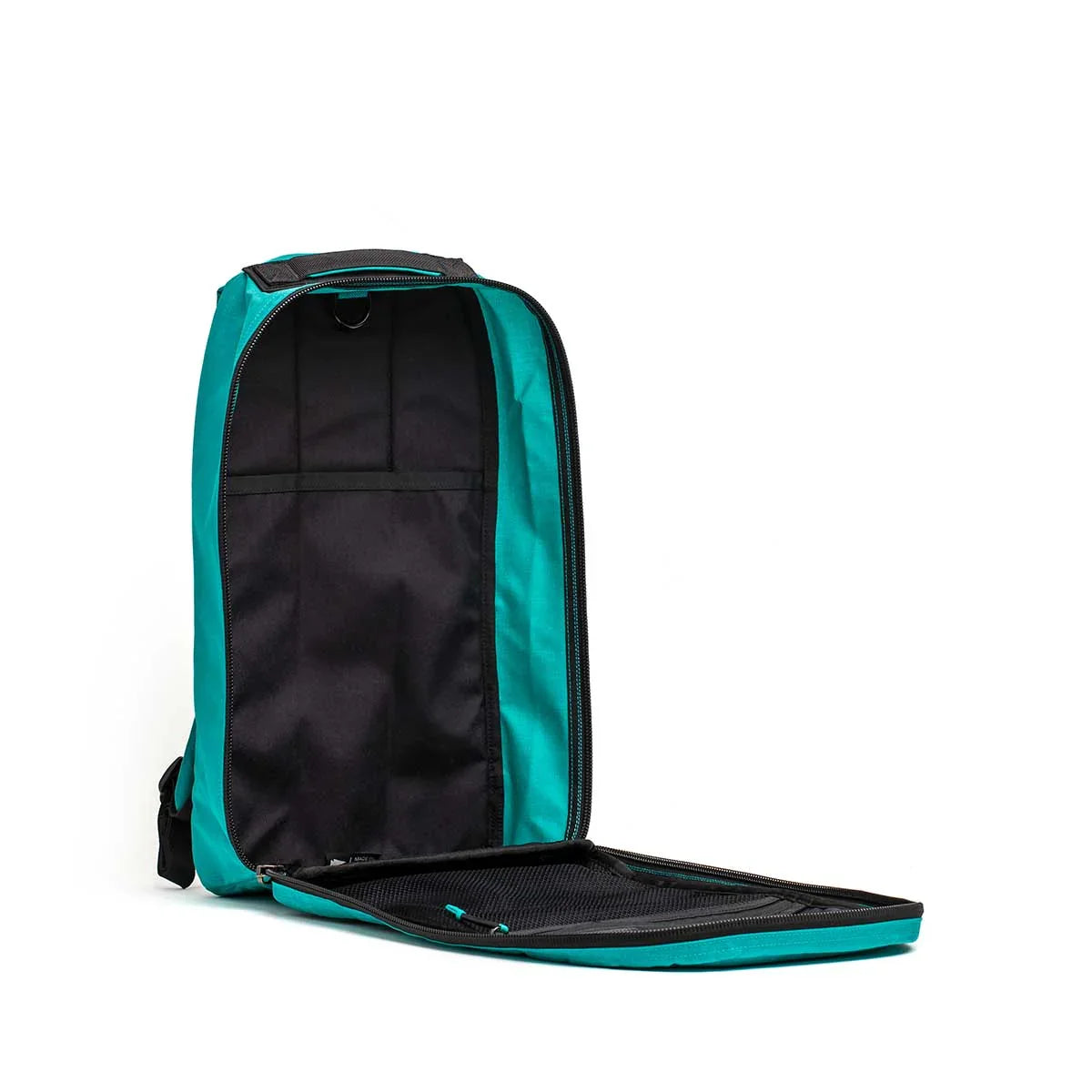 Open teal and black GORUCK backpack showing interior compartments and mesh organizer panel