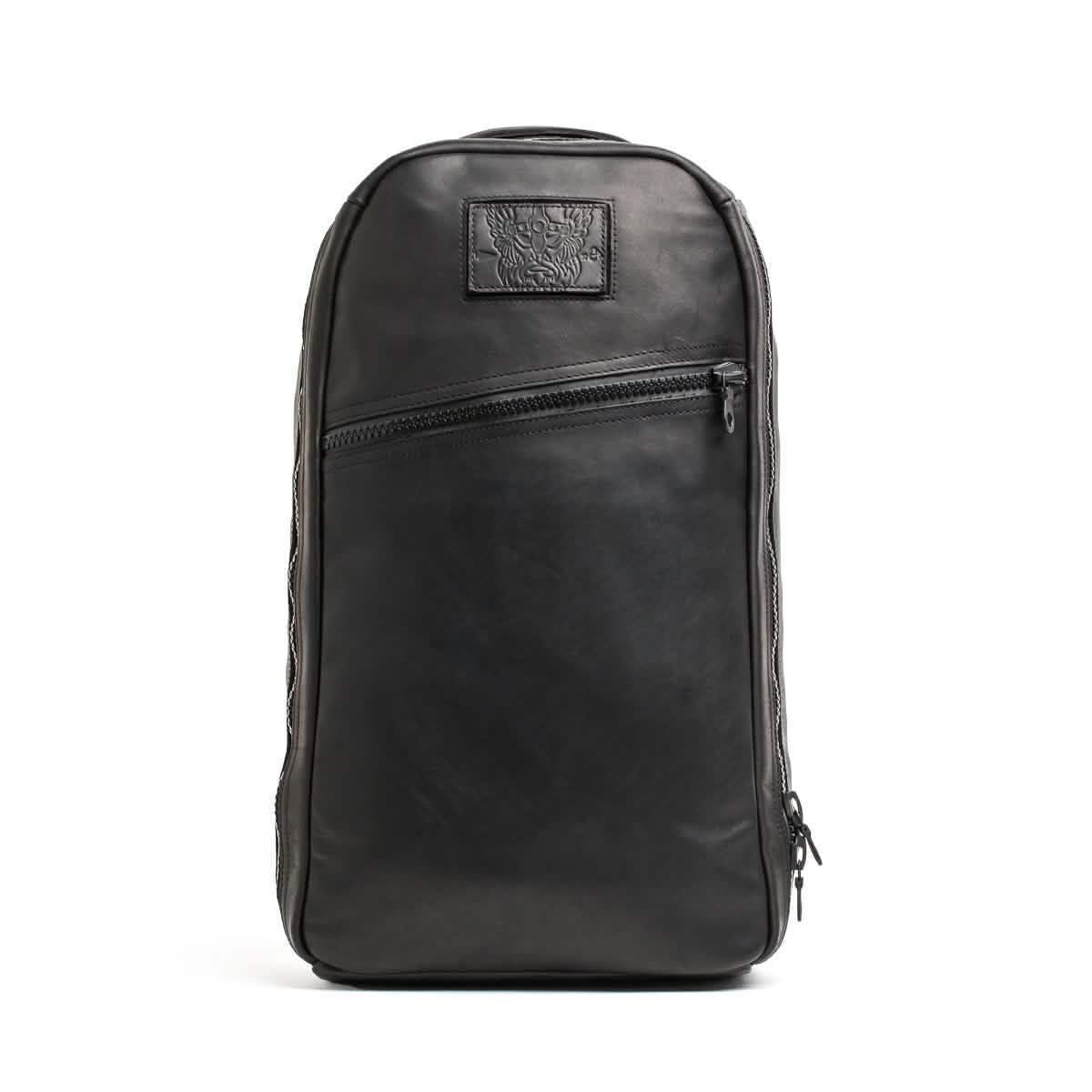 Black leather GORUCK Bullet 15L backpack with a diagonal front zipper pocket and embossed logo patch
