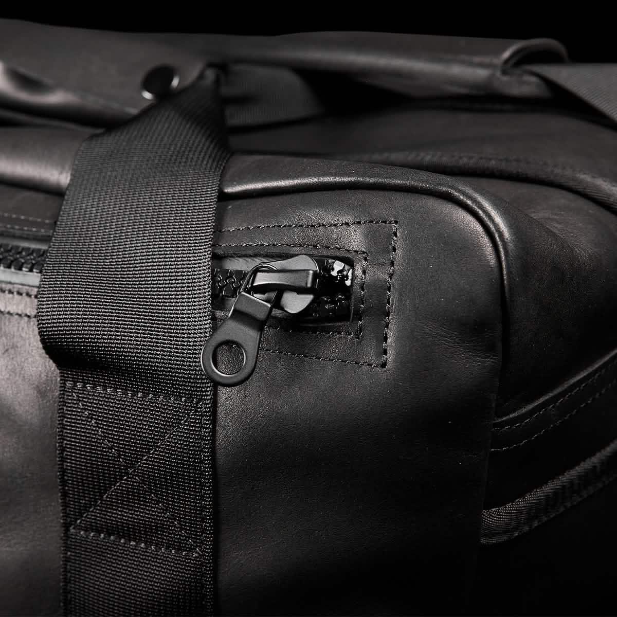 Close-up of GORUCK black kit bag with durable strap and rugged zipper detail
