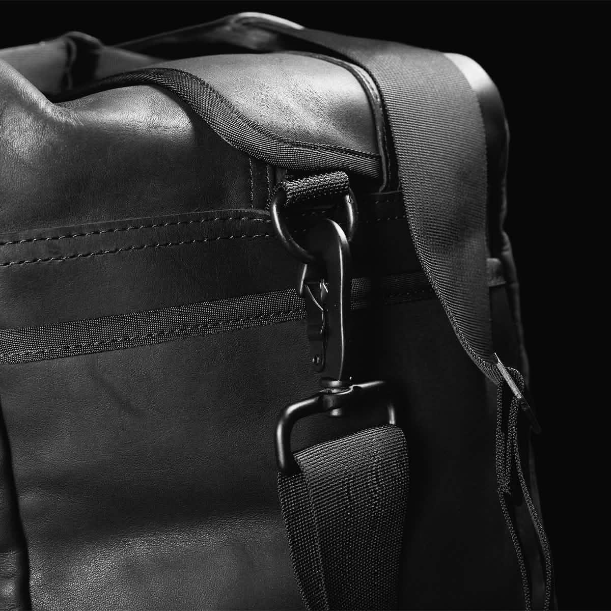 GORUCK black kit bag close-up featuring durable strap and metal carabiner clip