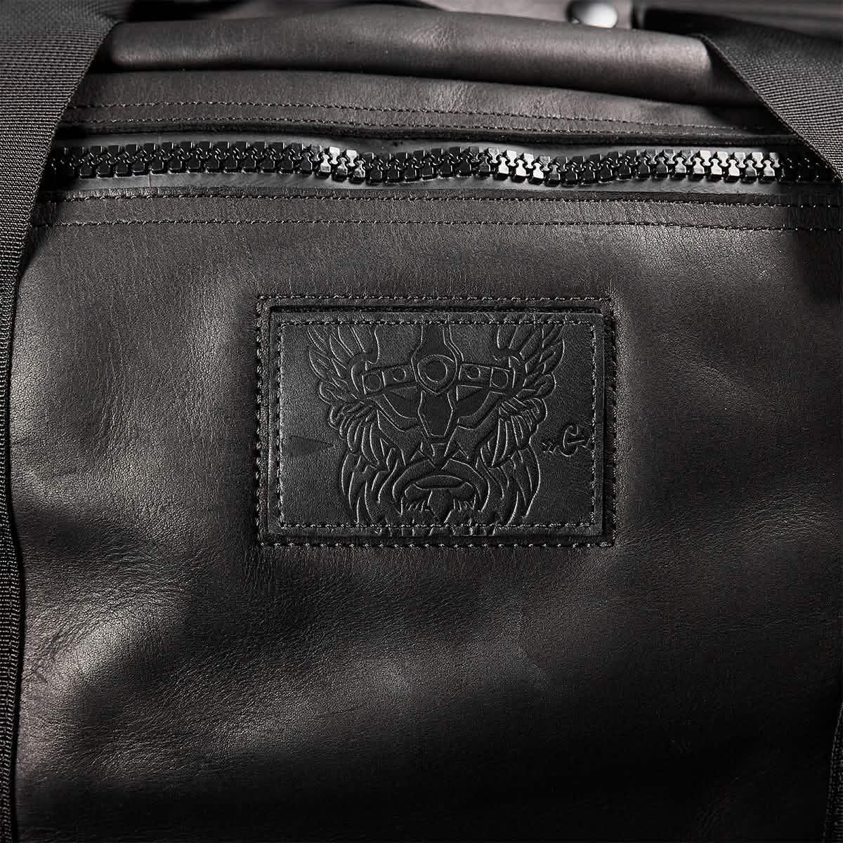 GORUCK black leather kit bag with embossed patch detail and front zipper pocket